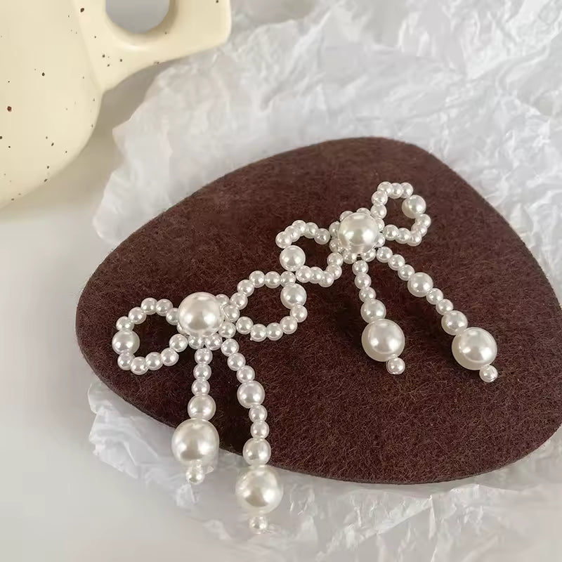 Pendientes de mujer de nuevo estilo, tendencia de moda, nudo de lazo de perla de imitación, temperamento elegante, pendientes bonitos para chica, regalo de vestir exquisito